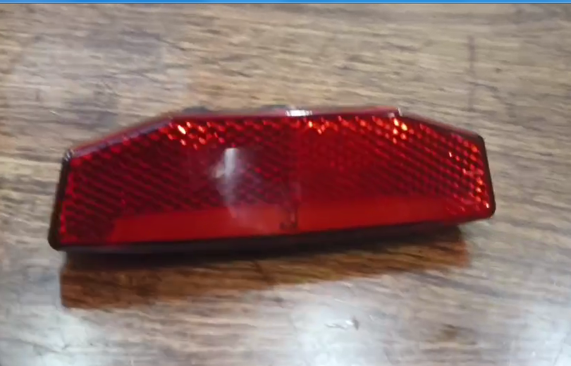 Rear tail light for LANKELEISI MG740PLUS e-bike, mounted on the bike’s rear, with clear lens and LED illumination.